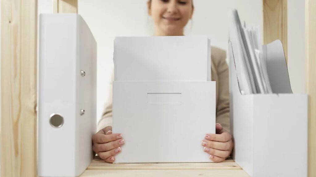 Florida divorce preparation: woman organizing divorce documents into folders using a Florida divorce document checklist