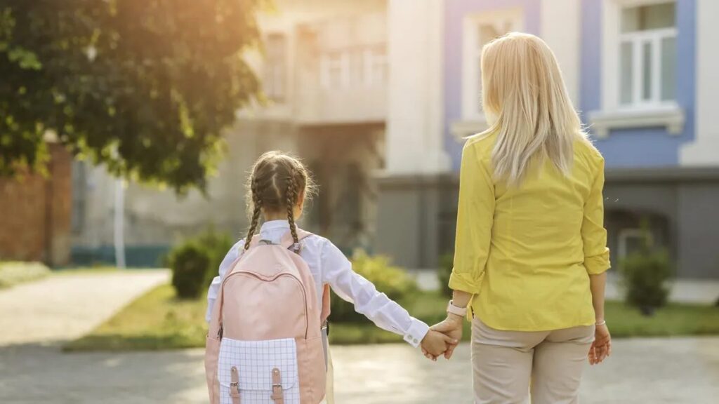 Parent walking a child to school holding hands — Florida custody checklist for a predictable exchange plan