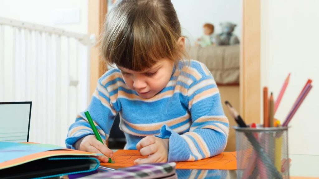 Young child drawing calmly at home — protecting children during divorce by keeping them out of the middle
