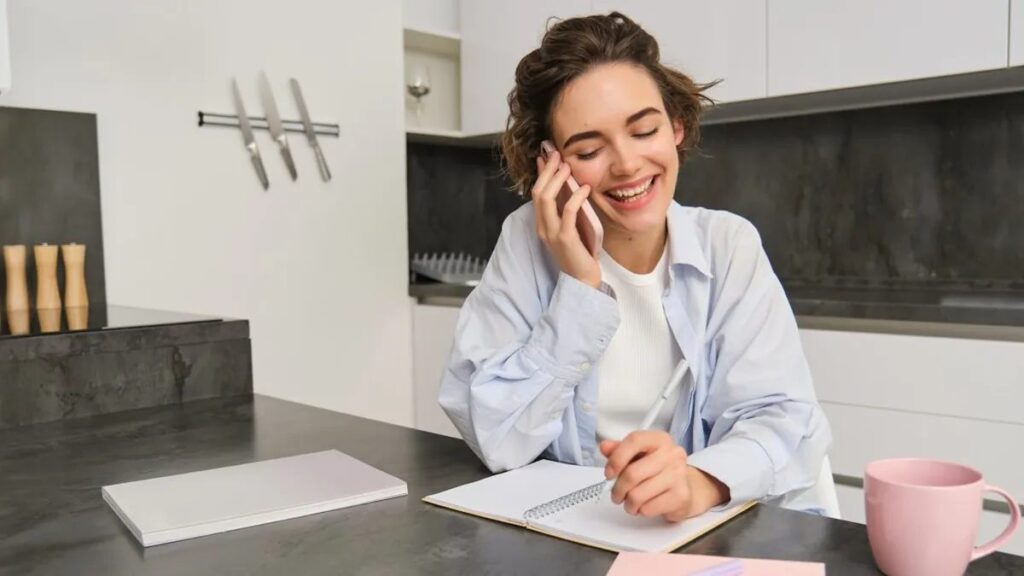 Woman on a private phone call taking notes while safety planning before a separation in Florida