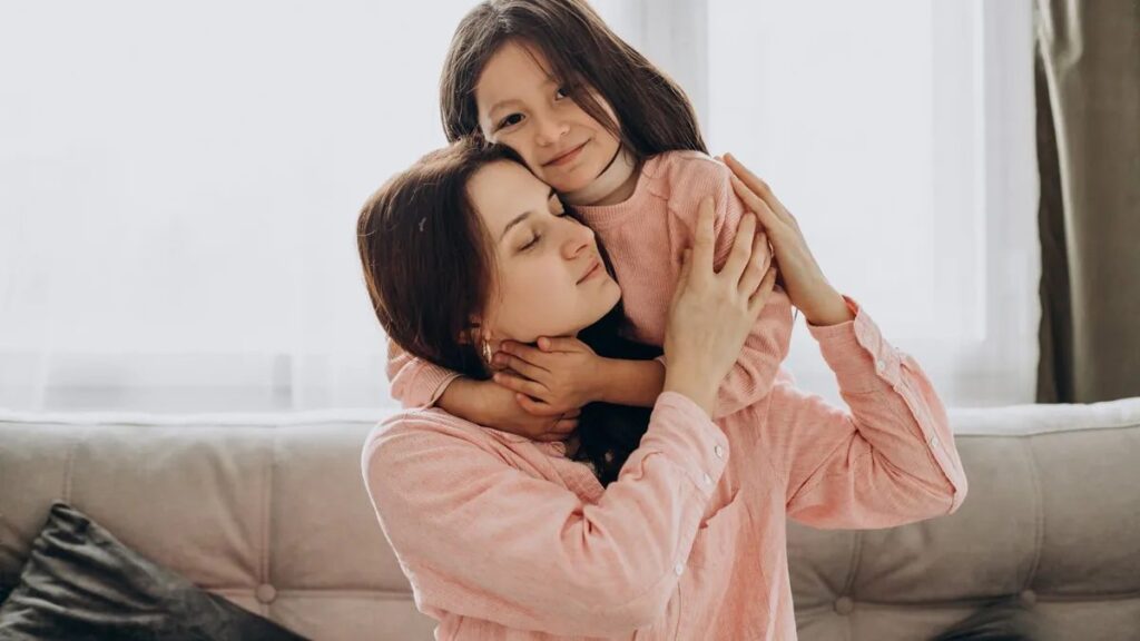 Mother hugging her daughter at home, protecting children during a high-conflict separation