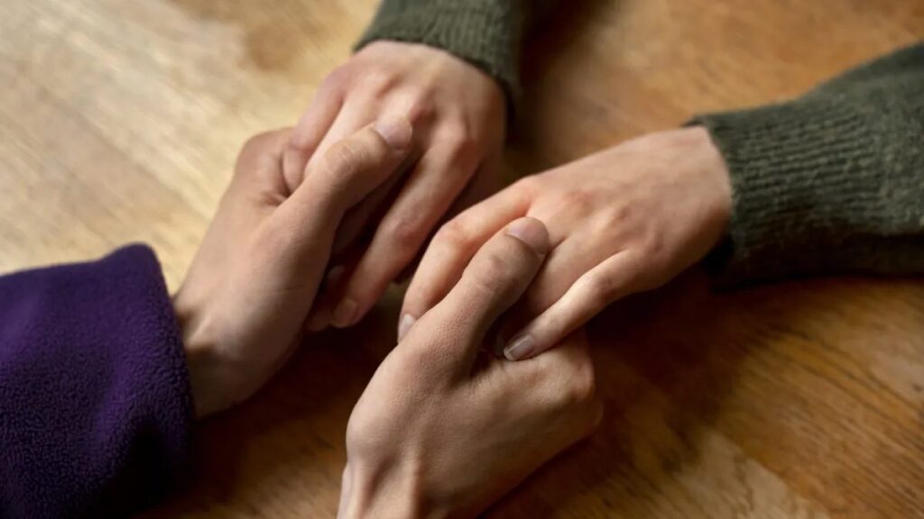 Two people holding hands in support — you do not have to go through a Florida separation alone